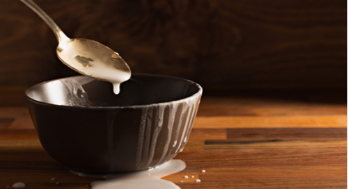 Spoon and bowl with spilled icing