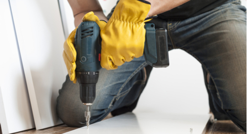 Worker drilling a hole