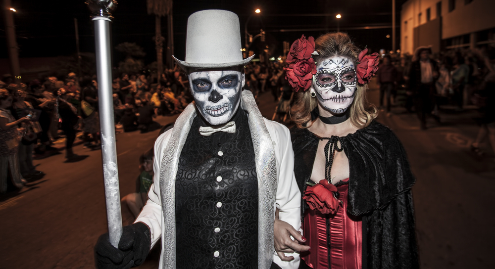 Two people in costume for an All Souls Procession.