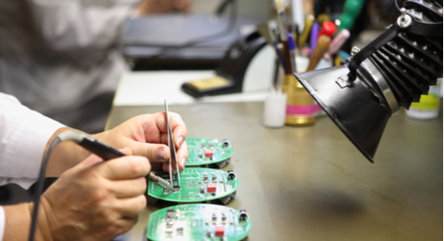 Manual assembly of circuit board soldering, close-up of the hand