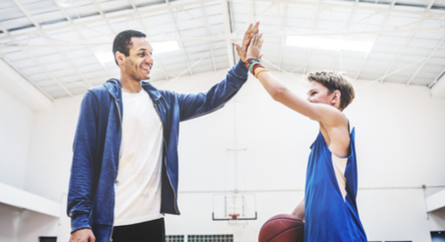 boy and coach high-fiving