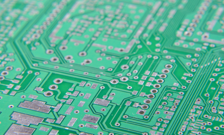 Traces and vias on a green PCB