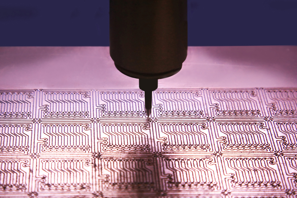 Drilling holes in the printed circuit board for mounting chips.